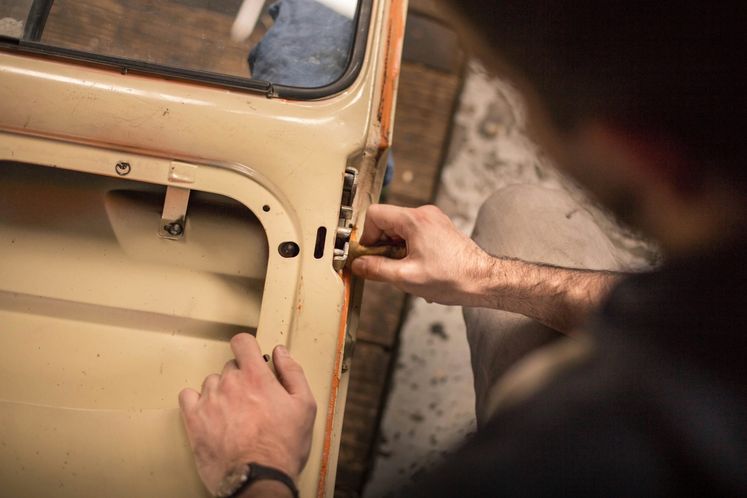 Mechanic repairing Tata Ace door lock and hinge